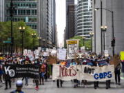 Chicago Teachers Union members and hundreds of supporters march through the Loop, Wednesday, June 24, 2020. The Chicago Teachers Union said Sunday, Jan. 24, 2021 that its members voted to defy an order to return to the classroom over concerns about COVID-19, setting up a showdown with district officials who have said such a move would amount to an illegal strike.