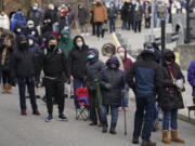 FILE - In this Jan. 21, 2021, file photo, people wait in line for the COVID-19 vaccine in Paterson, N.J. A racial gap has opened up in the nation&#039;s COVID-19 vaccination drive, with Black Americans in many places lagging behind whites in receiving shots, an Associated Press analysis shows.