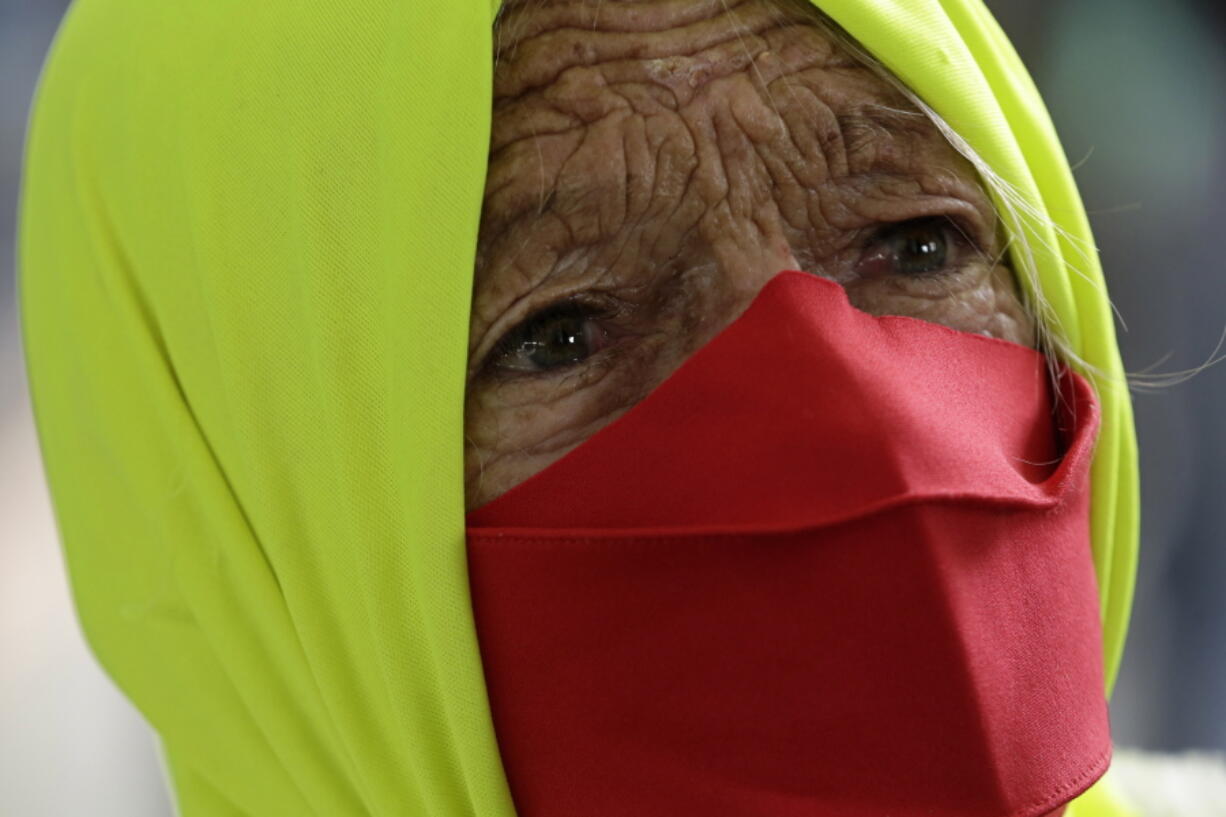 FILE - In this Dec. 23, 2020 file photo, a woman participates in a protest against Brazilian President Jair Bolsonaro&#039;s handling of the new coronavirus pandemic in Brazilia, Brazil. The country hasn&#039;t approved a single vaccine yet, and independent health experts who participated in its immunization program say the plan is still incomplete, at best.