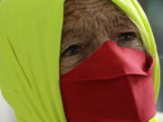 FILE - In this Dec. 23, 2020 file photo, a woman participates in a protest against Brazilian President Jair Bolsonaro&#039;s handling of the new coronavirus pandemic in Brazilia, Brazil. The country hasn&#039;t approved a single vaccine yet, and independent health experts who participated in its immunization program say the plan is still incomplete, at best.