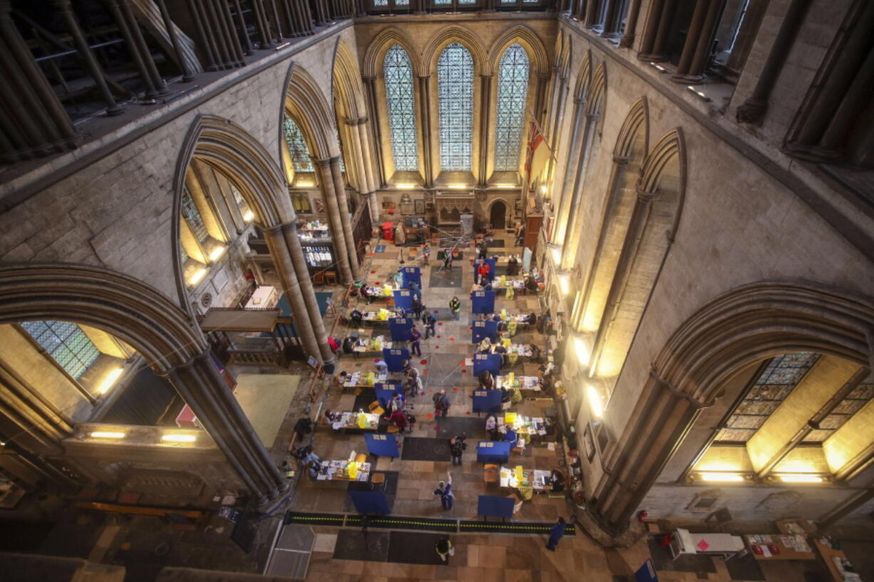 Cubicles erected inside Salisbury Cathedral, for people to receive a dose of the Pfizer-BioNTech coronavirus vaccine, in Salisbury, England, Saturday, Jan. 16, 2021.  Vaccination centers are being opened in England at some of the country&#039;s great cathedrals. Salisbury Cathedral, which also houses a copy of the Magna Carta, opened its great nave to the public. Others will follow as the rollout continues. Organ music played as the jabs were delivered at Salisbury and requests were even taken.