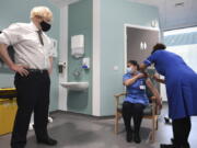 Britain&#039;s Prime Minister Boris Johnson watches as nurse Jennifer Dumasi is injected with the Oxford-AstraZeneca Covid-19 vaccine, during a visit to view the vaccination programme at the Chase Farm Hospital in north London, Monday Jan. 4, 2021, part of the Royal Free London NHS Foundation Trust.