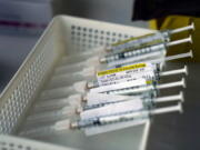 Syringes containing the Pfizer-BioNTech COVID-19 vaccine sit in a tray in a vaccination room at St. Joseph Hospital in Orange, Calif., Thursday, Jan. 7, 2021. (AP Photo/Jae C.