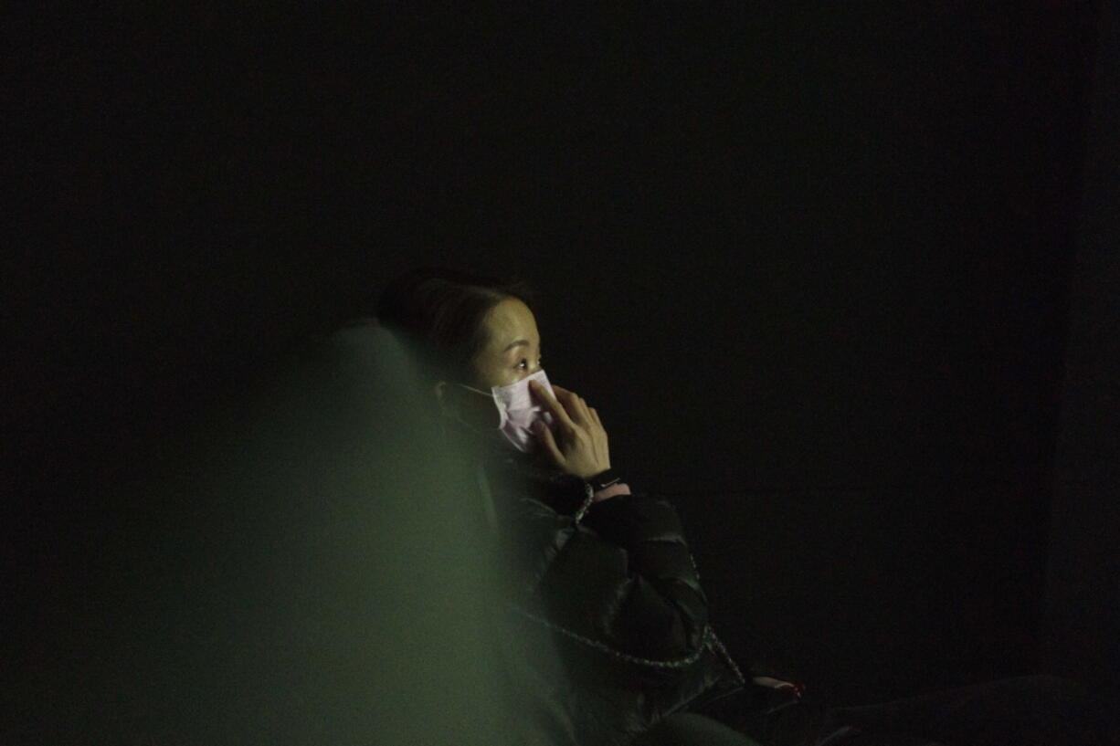 A lone movie goer attends the first screening of the film &quot;Days and Nights in Wuhan&quot; in a cineplex in Wuhan in central China&#039;s Hubei province on Friday, Jan. 22, 2021. China is rolling out the state-backed film praising Wuhan ahead of the anniversary of the 76-day lockdown in the central Chinese city where the coronavirus was first detected.