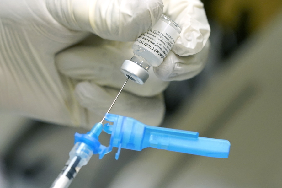 FILE - In this Dec. 16, 2020, file photo, a registered nurse prepares a syringe with the first round of the Pfizer COVID vaccination in Ridgeland, Miss., as state medical leaders received inoculations. On Friday, Dec. 18, 2020, The coronavirus vaccines have been rolled out unevenly across the U.S., but some states in the Deep South have had particularly dismal inoculation rates. (AP Photo/Rogelio V.