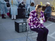 Amalia Ayala, front, a resident of Las Brisas Sunset senior apartment complex in San Luis, Ariz., deposits saliva for her COVID-19 test during the ASU and Equality Health Foundation pilot program on Friday, Jan. 15, 2021. Free saliva tests engineered by Arizona State University&#039;s Biodesign Institute are administered in Yuma County&#039;s small border city of San Luis to disabled and older people living in subsidized housing. The tests have also been given to hundreds of farmworkers.