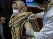 A hospital staff receives a COVID-19 vaccine at a government Hospital in Srinagar, Indian controlled Kashmir, Saturday, Jan. 16, 2021. India started inoculating health workers Saturday in what is likely the world&#039;s largest COVID-19 vaccination campaign, joining the ranks of wealthier nations where the effort is already well underway.