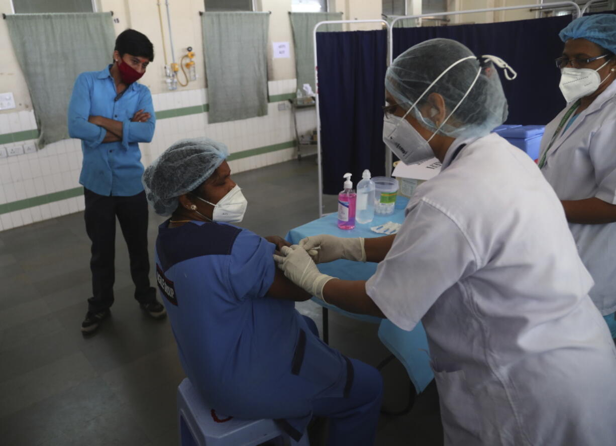 Health workers participate in a COVID-19 vaccine delivery system trial in Hyderabad, India, Saturday, Jan. 2, 2021. India tested its COVID-19 vaccine delivery system with a nationwide trial on Saturday as it prepares to roll-out an inoculation program to stem the coronavirus pandemic.