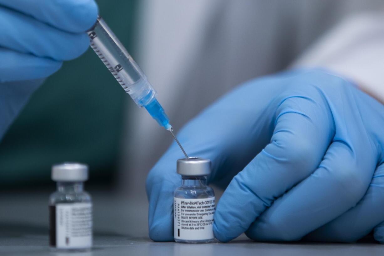 FILE - In this Jan. 12, 2021 file photo, a health care professional prepares a Pfizer-BioNTech COVID-19 vaccine at Sheba Tel Hashomer Hospital in Ramat Gan, Israel. Israel Defense Minister Benny Gantz&#039;s office said Sundya, Jan. 31, 2021, that Israel has agreed to transfer 5,000 doses of the coronavirus vaccine to the Palestinians to immunize front-line medical workers. It is the first time that Israel has confirmed the transfer of vaccines to the Palestinians.