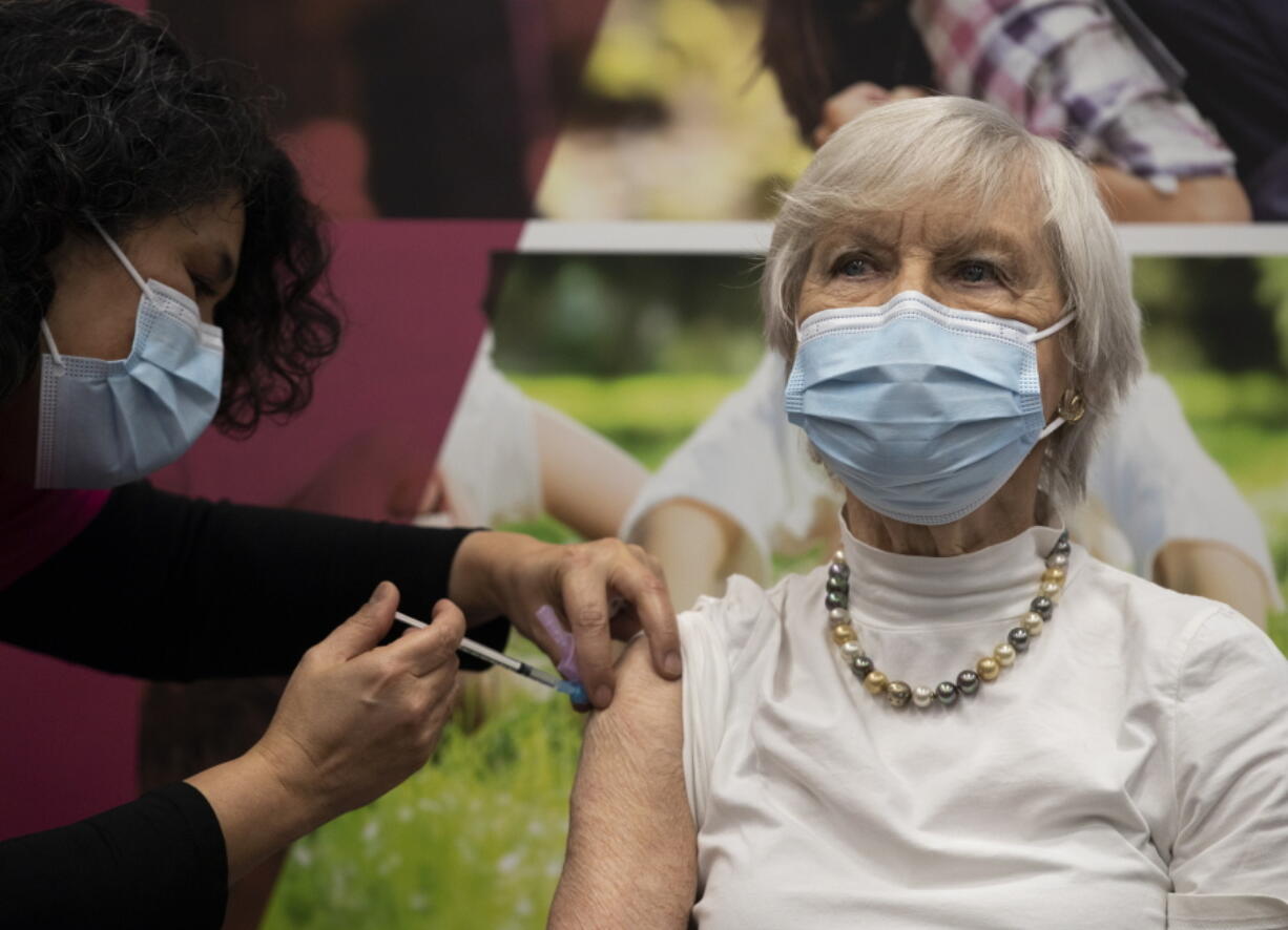 Ans Lock van de Veen, 91, is injected with a COVID-19 vaccine in Apeldoorn, Netherlands, Tuesday, Jan. 26, 2021. Dutch authorities began vaccinating the first of thousands of people aged over 90 years who still live at home.