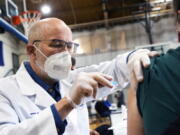 University of Scranton nursing student Glen Johnson administers the Moderna COVID-19 vaccine to a medical professional during a clinic at the Throop Civic Center in Throop, Pa. on Saturday, Jan. 9, 2021. The Lackawanna County Medical Society had about 400 doses of the Moderna vaccine on hand to administer to people in Pennsylvania&#039;s Phase 1A group of the vaccine rollout plan, which is limited to healthcare personnel and long-term care facility residents.