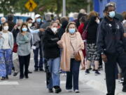 FILE - In this Jan. 6, 2021, file photo, people arrive at Jackson Memorial Hospital to receive the COVID-19 vaccine in Miami. With frustration rising over the slow rollout of the vaccine, state leaders and other politicians are turning up the pressure, improvising and seeking to bend the rules to get shots in arms more quickly.