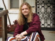 Jesse Robinson sits on his porch, Thursday, Jan. 21, 2021, in Nashville, Tenn. Robinson has received his first dose of the COVID-19 vaccine. With millions of Americans waiting for their chance to get the coronavirus vaccine, a fortunate few are getting bumped to the front of the line as clinics scramble to get rid of extra, perishable doses at the end of the day.