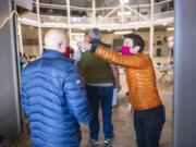 Nikki Sharp takes temperatures at a mass vaccination clinic at the Walla Walla Fairgrounds pavilion Saturday, Jan. 23, 2020, in Walla Walla, Wash.