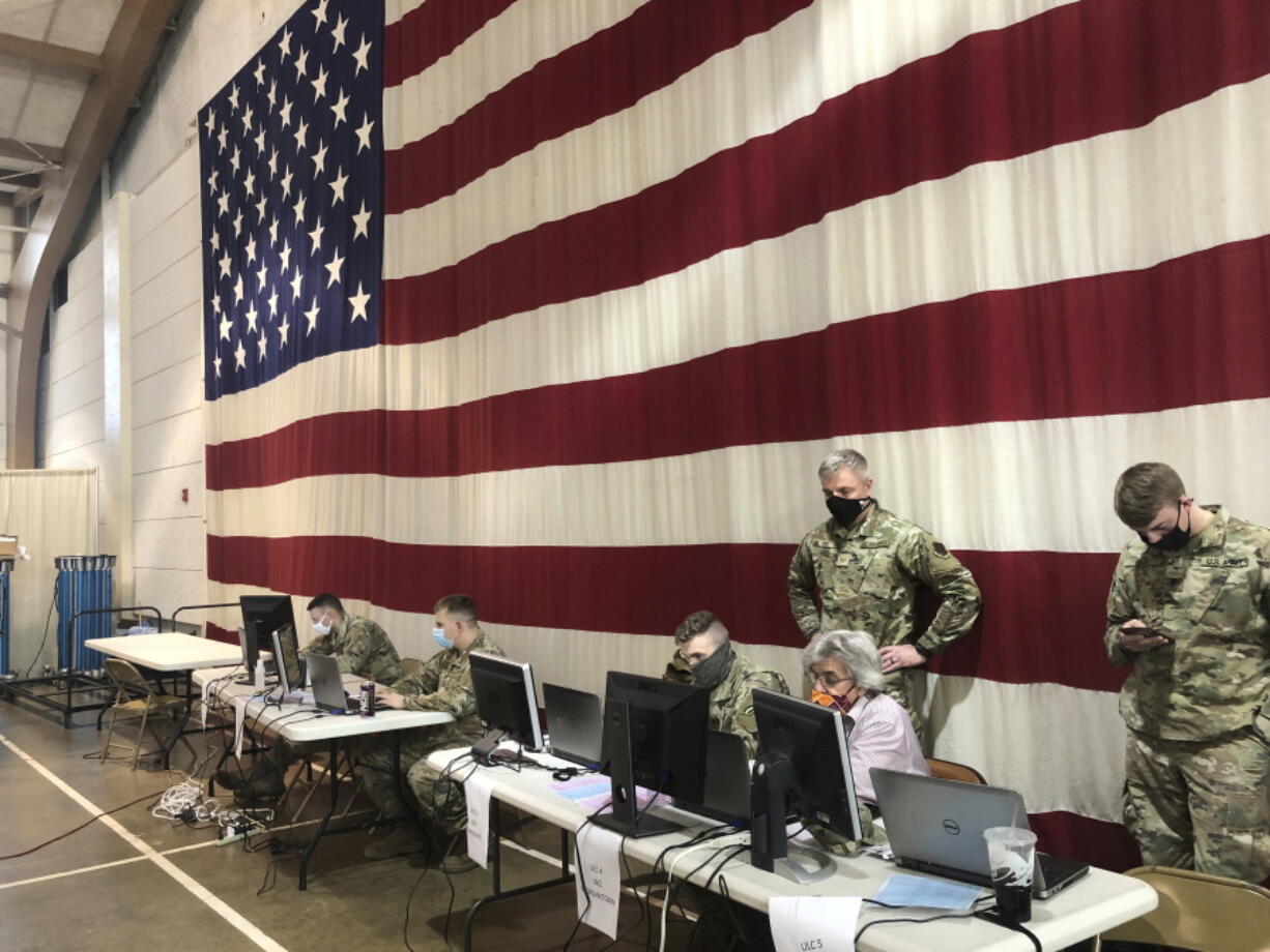 Members of the West Virginia National Guard monitor statewide efforts to distribute COVID-19 vaccines Thursday, Jan. 14, 2021, at the National Guard Joint Forces headquarters in Charleston, W.Va. West Virginia has emerged an unlikely success in the nation&#039;s otherwise chaotic vaccine rollout. Officials also credit a 50-person command center at the state&#039;s National Guard headquarters just outside the capital of Charleston.