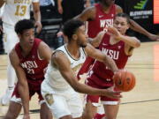 Colorado guard D&#039;Shawn Schwartz, front, passes the ball as Washington State center Dishon Jackson, left, and forward DJ Rodman defend during the second half of an NCAA college basketball game Wednesday, Jan. 27, 2021, in Boulder, Colo.