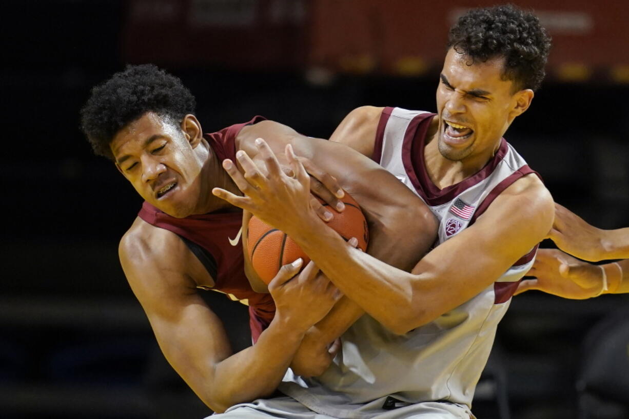 Washington State center Dishon Jackson, left, wrestles for the ball with Stanford forward Oscar da Silva during the second half of an NCAA college basketball game in Santa Cruz, Calif., Saturday, Jan. 9, 2021.