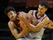 Washington State center Dishon Jackson, left, wrestles for the ball with Stanford forward Oscar da Silva during the second half of an NCAA college basketball game in Santa Cruz, Calif., Saturday, Jan. 9, 2021.