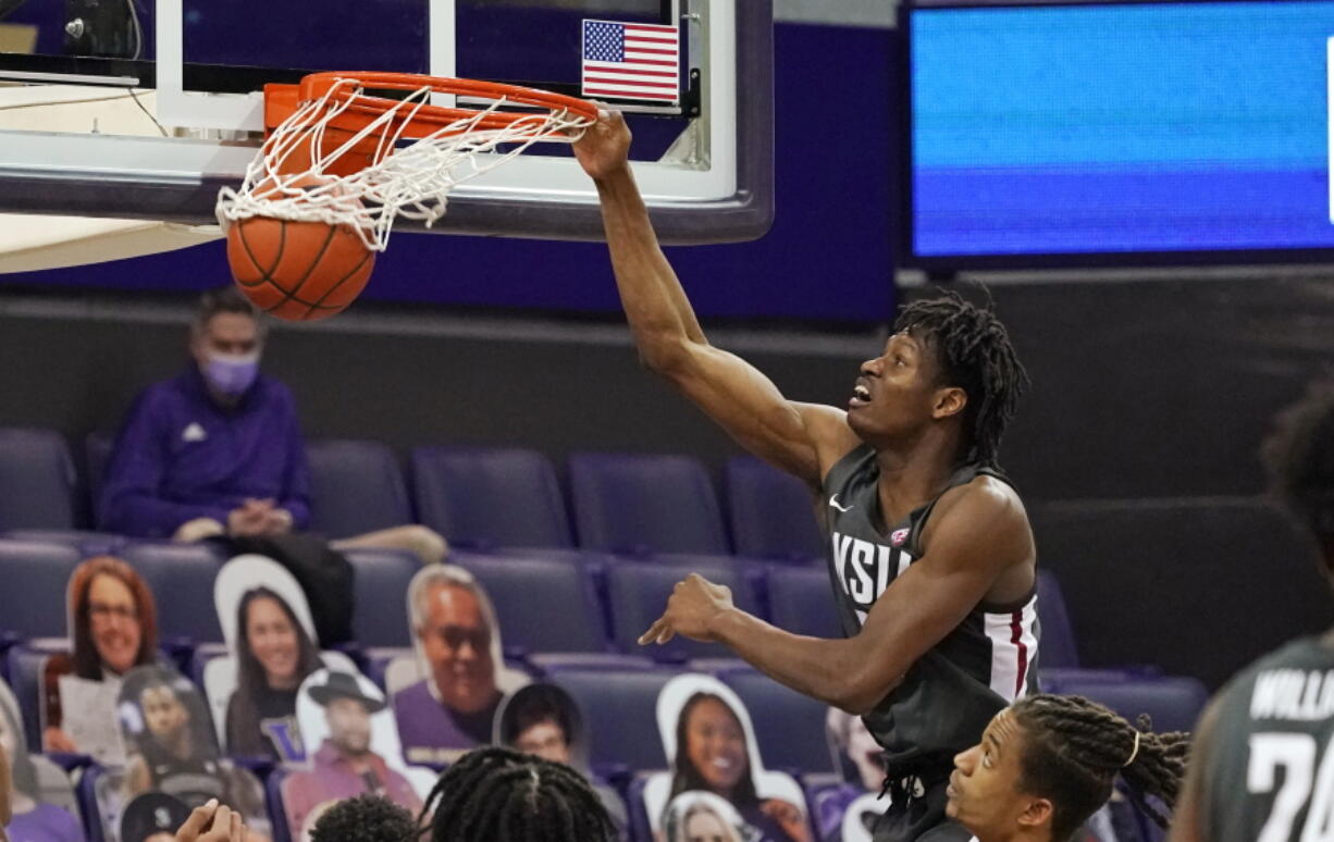 Washington State&#039;s Efe Abogidi dunks against Washington in the first half of an NCAA college basketball game Sunday, Jan. 31, 2021, in Seattle.