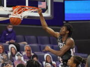 Washington State&#039;s Efe Abogidi dunks against Washington in the first half of an NCAA college basketball game Sunday, Jan. 31, 2021, in Seattle.