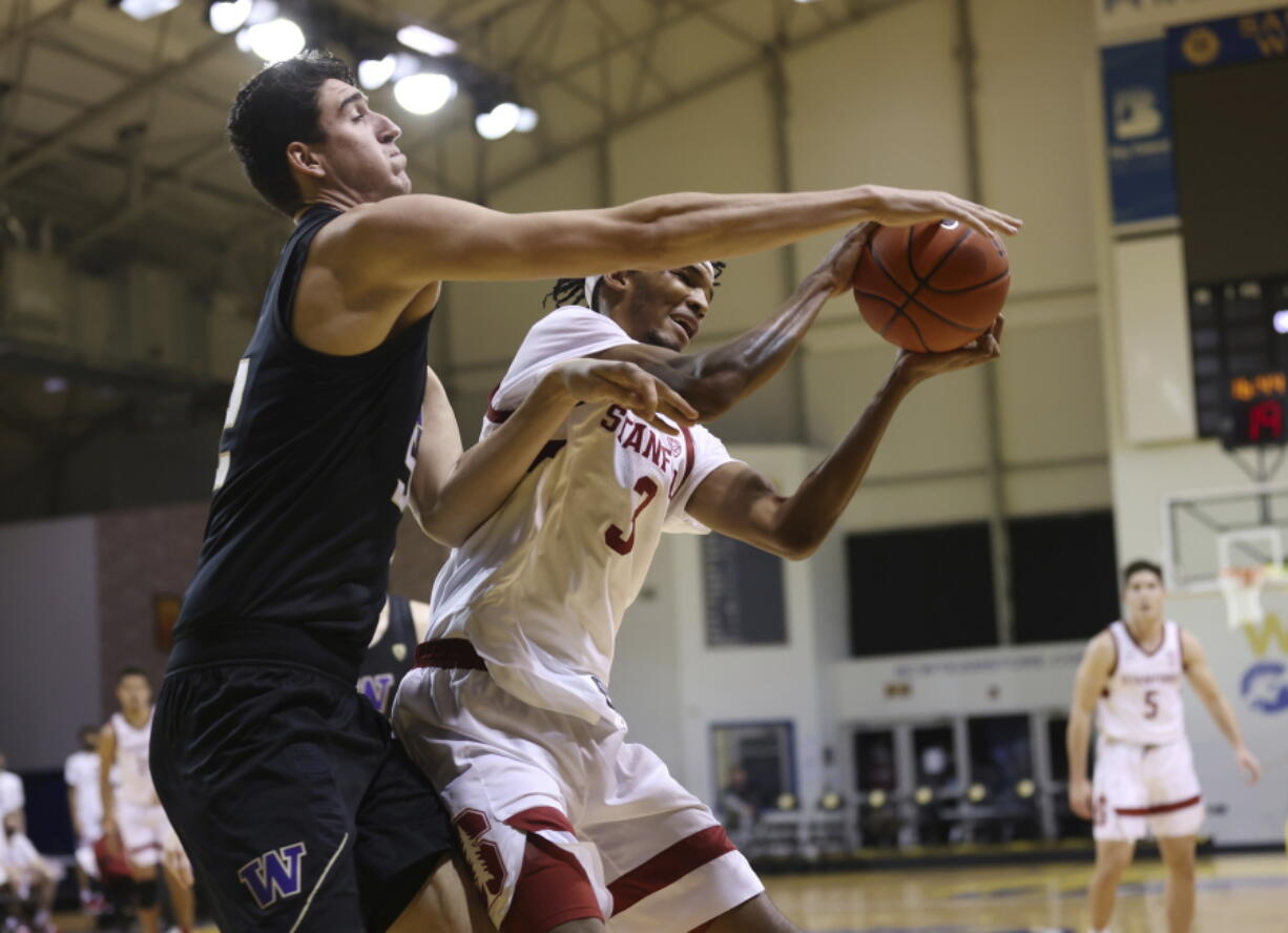 Washington center Riley Sorn (52), left, defends a shot against Stanford forward Ziaire Williams (3) during the first half of an NCAA college basketball game in Santa Cruz, Calif., Thursday, Jan. 7, 2021.