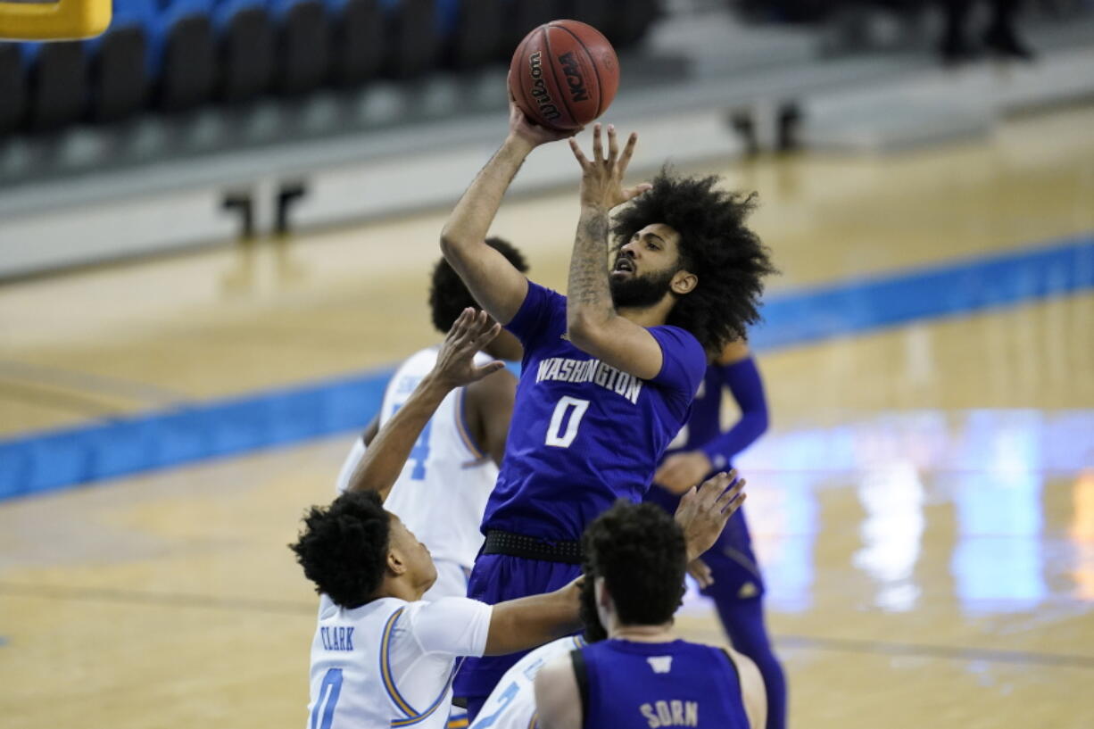 Washington guard Marcus Tsohonis (0) takes a shot against UCLA guard Jaylen Clark (0) during the first half of an NCAA college basketball game Saturday, Jan. 16, 2021, in Los Angeles.