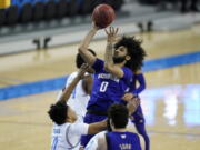 Washington guard Marcus Tsohonis (0) takes a shot against UCLA guard Jaylen Clark (0) during the first half of an NCAA college basketball game Saturday, Jan. 16, 2021, in Los Angeles.