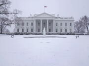 Snow falls on the North Lawn of the White House, Sunday, Jan. 31, 2021, in Washington.