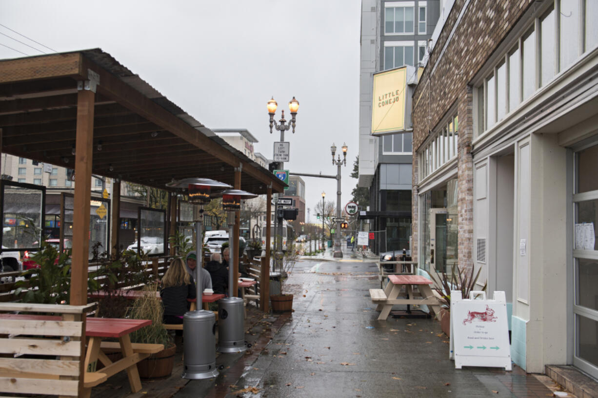 Customers take shelter in an outdoor dining area of Little Conejo in downtown Vancouver. Declining COVID-19 activity has allowed Clark County to move into Phase 2 of the state&#039;s reopening plan, which will allow indoor dining, with restrictions, to resume on Monday.