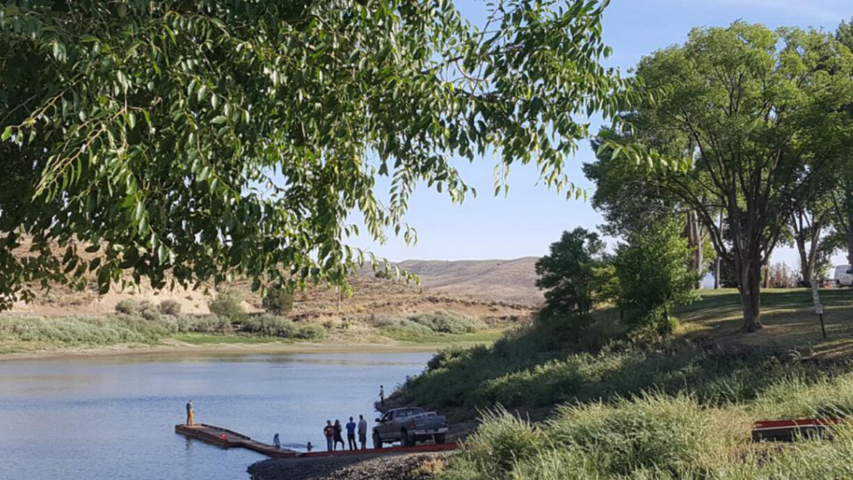 People gather on the boat dock at Unity Lake State Recreation Area in Eastern Oregon.