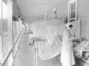 A nurse takes the pulse of a patient in the influenza ward of the Walter Reed hospital in Washington in November 1918. According to the Centers for Disease Control and Prevention, the number of U.S. deaths from the Spanish flu pandemic was estimated to be about 675,000.