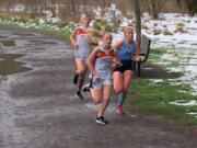 Washougal freshman Elle Thomas runs ahead of Hockinson senior Allyson Peterson and Washougal sophomore Sydnee Boothby during a 5,000 meter race Thursday at Hockinson Meadows Community Park. Thomas won in 18 minutes, 57 seconds.