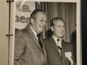 Attorney Kent Hipp shows a photo of Walt Disney and Major General William &quot;Joe&quot; Potter, from a photo album.