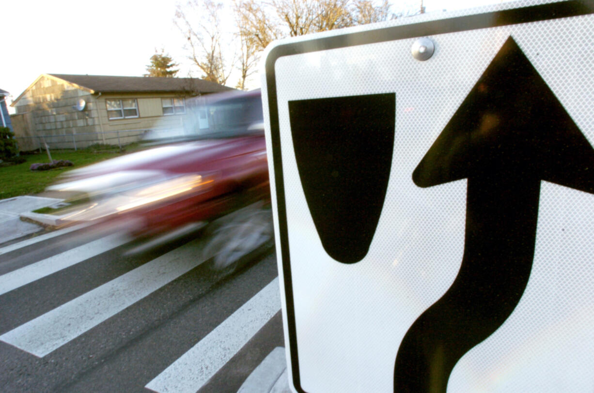 A truck drives by a traffic island on Lieser Road. The city is reviving a traffic-calming program suspended in 2020.