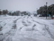 A winter storm that brought snow, ice, and plunging temperatures across Central Texas shut down roads and caused the electrical grid to shut down, leaving thousands of people without power. (Ricardo B.