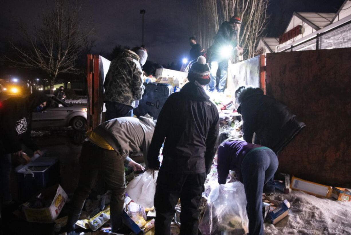 Portlanders forage in large dumpsters full of perishable food after Fred Meyer tossed food due to losing electricity.Monday, February 15, 2020.