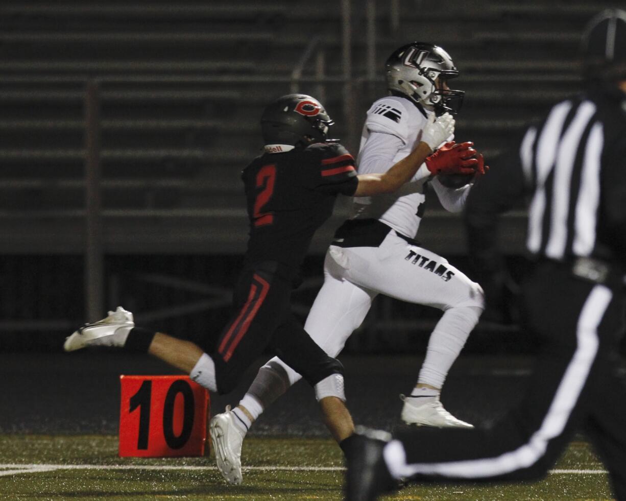 Union wide receiver Jake Bowen, right, catches a long pass against Camas defender Zach Blair.