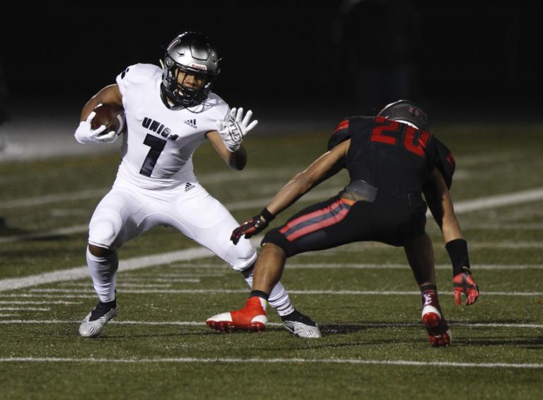 Union running back Jaydon Jones, left, runs after a catch as Camas corner back Mark Harimoto, right defends.(Photo by Steve Dipaola for The Columbian)