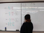 A student looks over math problems on the whiteboard at the Learning Support Center, which is part of the Family Promise of Clark County&#039;s FP Cares Educational Services that launched in November.