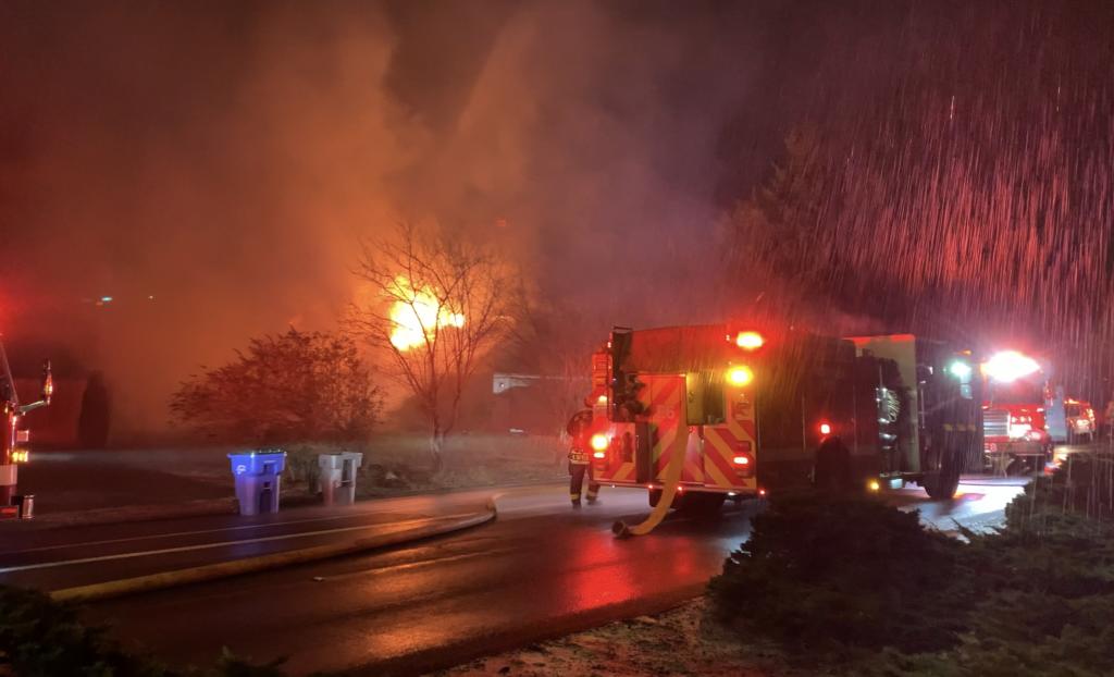 Vancouver firefighters on the scene of a house fire Thursday night on Southeast McGillivray Boulevard.