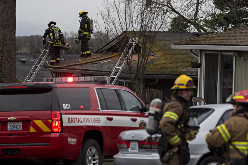 Firefighters respond to a blaze in two units at the Logan's Court duplex complex in Vancouver's Lincoln neighborhood on Monday afternoon, Feb. 22, 2021.