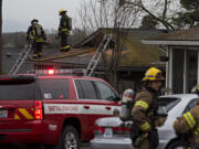Firefighters respond to a blaze in two units at the Logan's Court duplex complex in Vancouver's Lincoln neighborhood on Monday afternoon, Feb. 22, 2021.