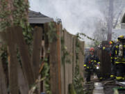 LEADSHOT Firefighters respond to a blaze in two units at the Logan's Court duplex complex in Vancouver's Lincoln neighborhood on Monday afternoon, Feb. 22, 2021.