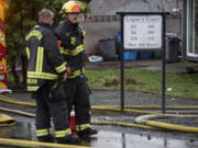 Firefighters work at the scene of a fire at Logan's Court duplex complex in Vancouver's Lincoln neighborhood on Monday afternoon, Feb. 22, 2021.