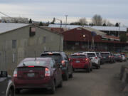 Cars line up Jan. 26 as people wait to get a COVID-19 vaccination at the Clark County Event Center at the Fairgrounds.