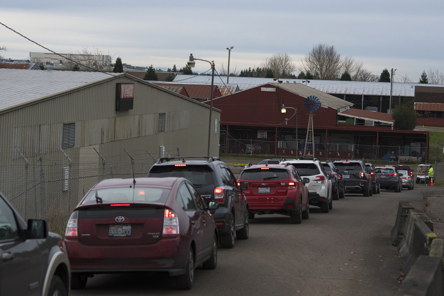 Cars line up Jan. 26 as people wait to get a COVID-19 vaccination at the Clark County Event Center at the Fairgrounds.