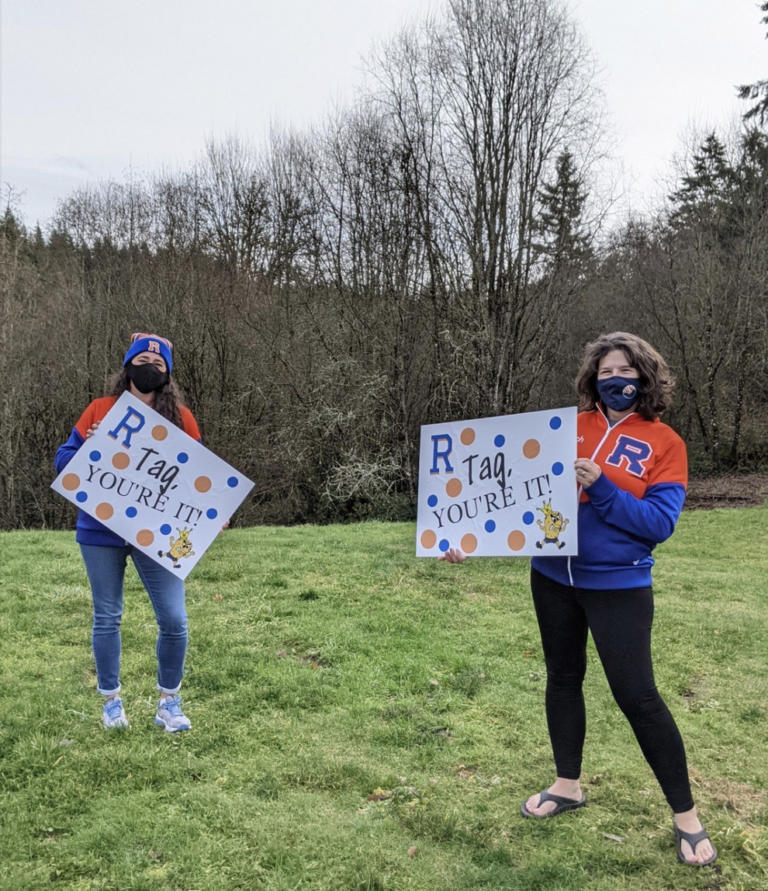 RIDGEFIELD: Cheerleading coaches Alyssa Tomillo and Anja Felton kicked off the game of yard sign tag.