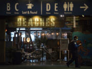 TSA Officer Raven Moore walks past the exterior of Beaches restaurant at Portland International Airport on Thursday morning. Beaches at the airport is closing at the end of March because the airport is being remodeled. The restaurant might not reopen after.