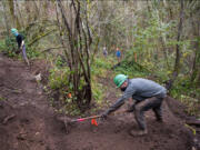 Washington Trails Association volunteers Andrew Leibrand, left, and Paul Pierce help create a new trail to Blandford Canyon on Friday during a Washington Trails Association work party near South Cliff Park. Volunteers continued the work on Saturday and Sunday.