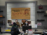 At left, sales associate Rachel Cummings helps a customer on Thursday at Spanky&#039;s. Owner Rachel Phillips bought the store 12 years ago, when it was on Main Street in downtown Vancouver.